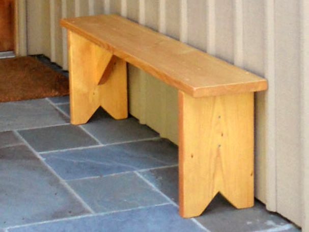 Commercial quality eco-friendly Outdoor Farmhouse Bench slightly slanted to the left on a patio.