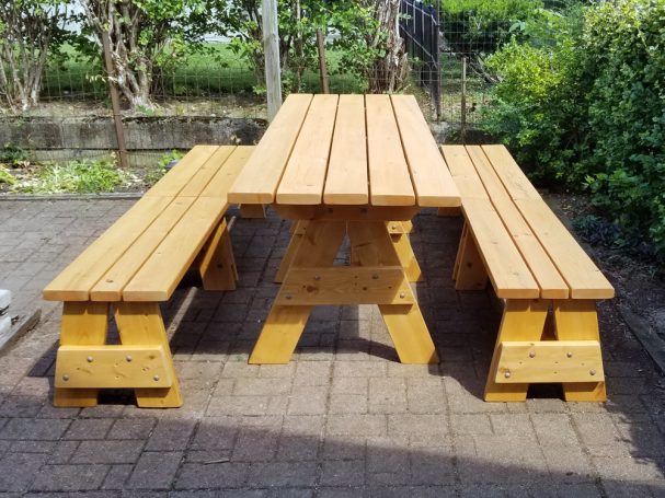 Commercial quality Custom Eco-friendly Outdoor Detached Bench Picnic Table with four benches from the front on a patio.