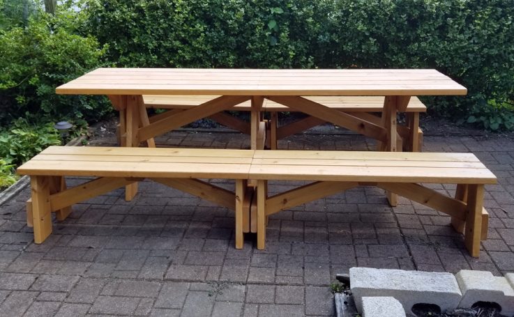 Commercial quality Custom Eco-friendly Outdoor Detached Bench Picnic Table with four benches from the side on a patio.